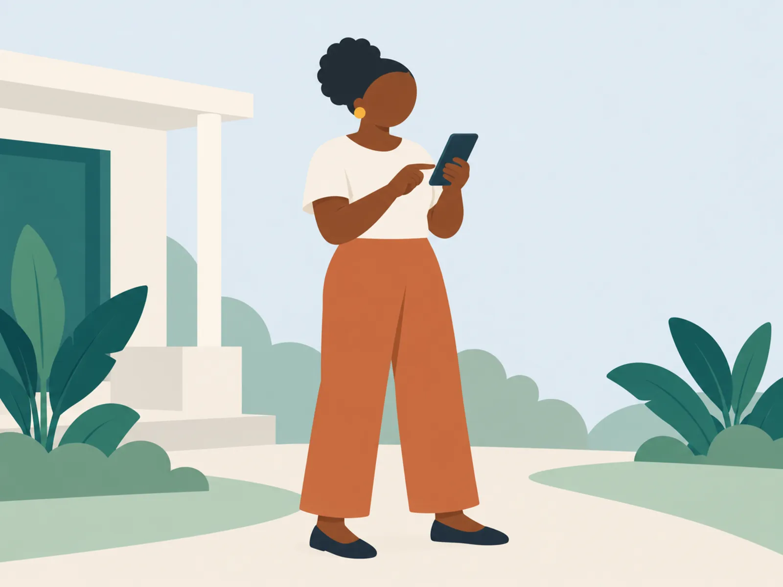 A woman standing outdoors using her phone