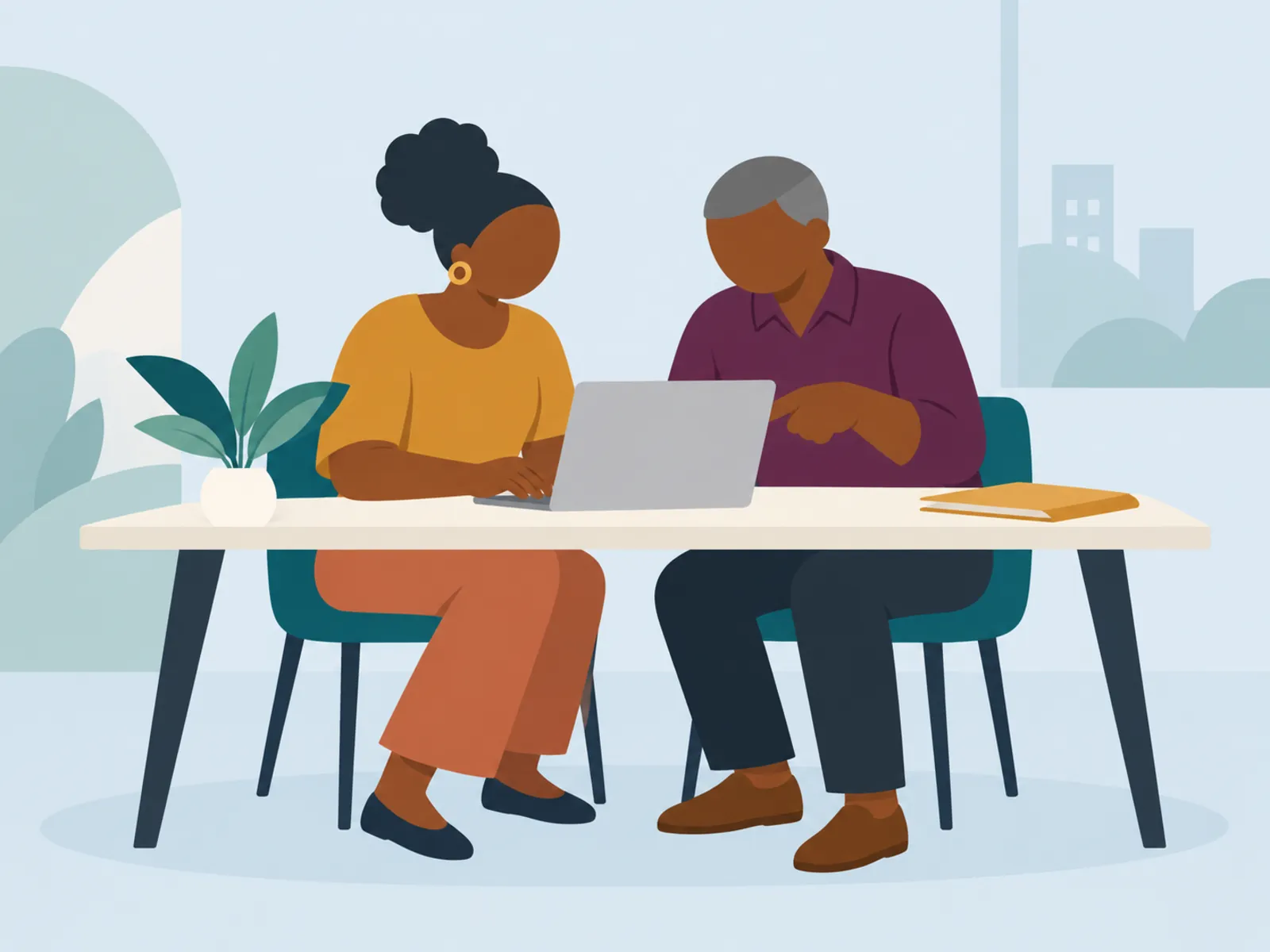 Two colleagues working together at a laptop